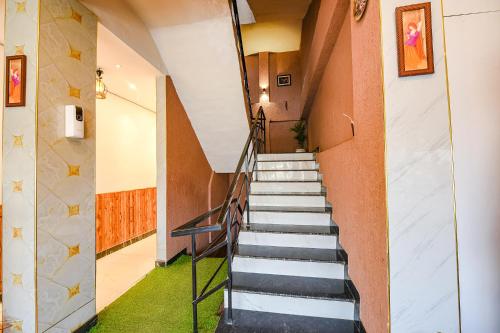 a staircase leading up to a building with green carpet at FabHotel The Dreams in Chandīgarh