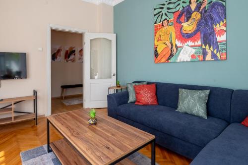 a living room with a blue couch and a table at Fully Equipped & Modern Designed Spectacular 3BR in Istanbul