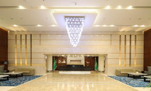 a large lobby with a chandelier in a building at Aerotel Jeddah in Jeddah