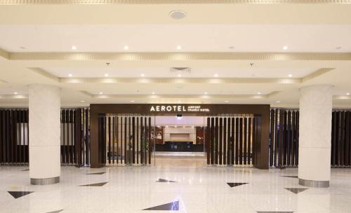 a hotel lobby with a hotel sign on the wall at Aerotel Jeddah in Jeddah