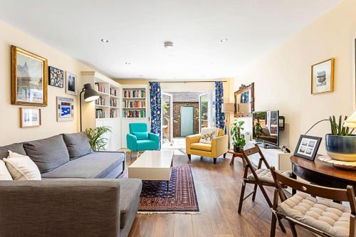 a living room with a couch and a table at Terraced Bermondsey House in London