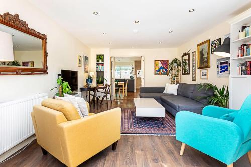 a living room with a couch and two chairs at Terraced Bermondsey House in London