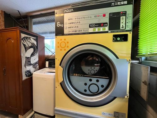 a washing machine is sitting in a room at まんのう清流庵 in Manno