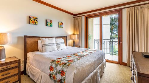 a bedroom with a bed and a window and a television at Ko Olina Beach Villas B403 in Kapolei