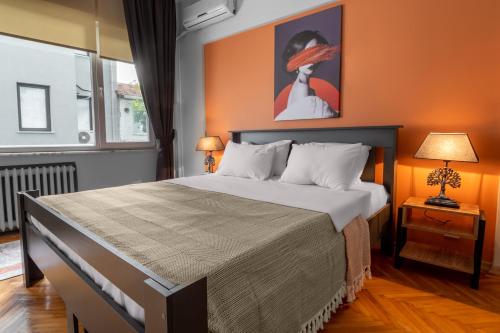 a bedroom with a large bed with an orange wall at Fully Equipped & Modern Designed Spectacular 3BR in Istanbul