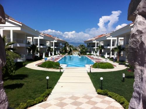 a view of the courtyard of a resort with a swimming pool at Wonderful 3 bed duplex in sought after prime community in Side