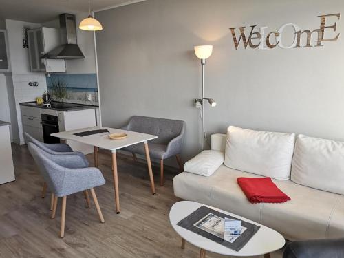 a living room with a couch and a table at Strandhotel Wohnung 68 in Dahme