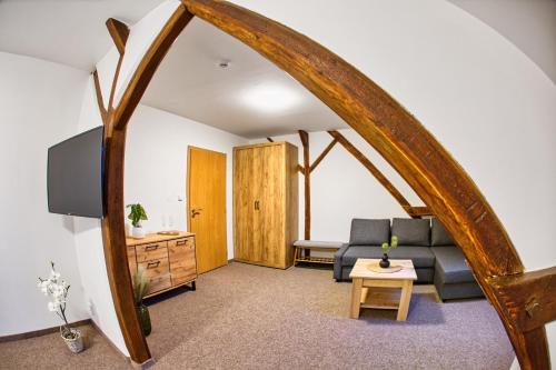 a living room with a couch and a table at Hotel a Restaurace Růže in Podbořany