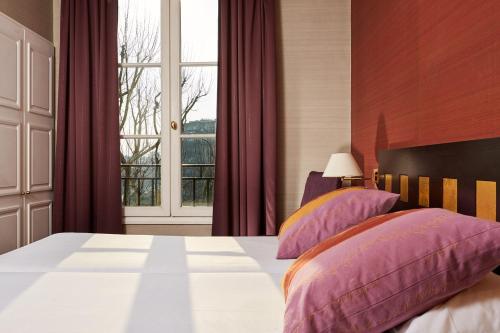 Postel nebo postele na pokoji v ubytování Hotel De La Jatte