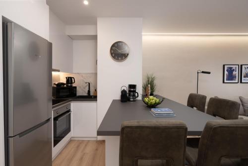 a kitchen and living room with a table and chairs at The Edge - Luxury Residences in Athens