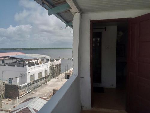 a door to a balcony with a view of the water at Al-reidy House in Lamu