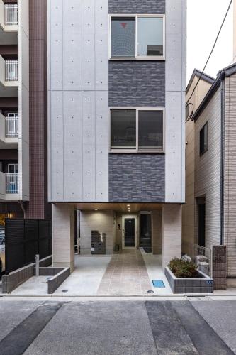 a large building with a courtyard in front of it at Float Inn Asakusa in Tokyo