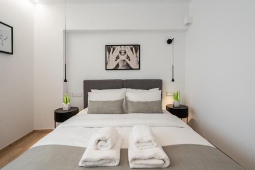a bedroom with a bed with two towels on it at The Edge - Luxury Residences in Athens