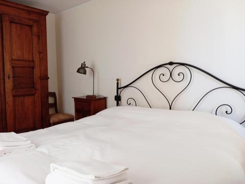 a bedroom with a white bed with a heart headboard at Morge La Salle in La Salle