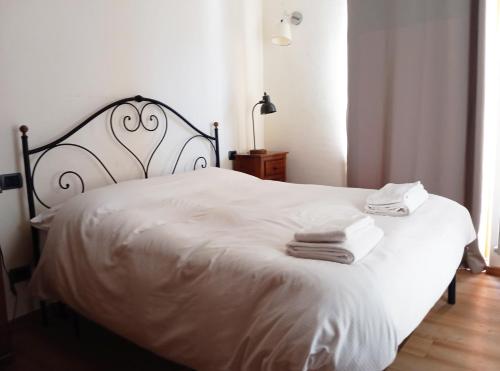 a bedroom with a white bed with towels on it at Morge La Salle in La Salle
