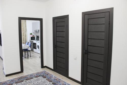 a room with two doors and a mirror at Апартаменты рядом с метро Раимбек in Almaty