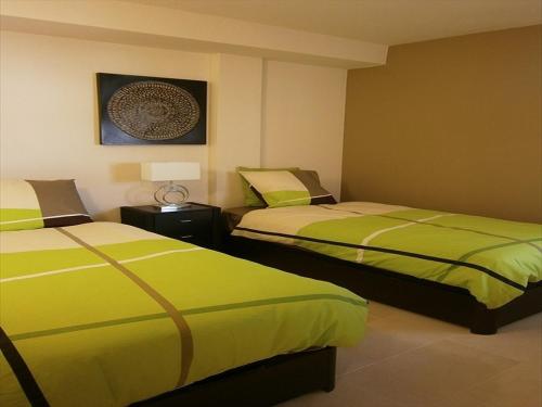 En eller flere senge i et værelse på Ashanti Bay Luxury Golf Apartment