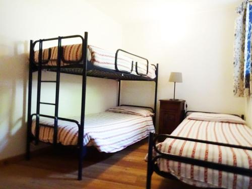 a bedroom with two bunk beds in a room at Morge La Salle in La Salle