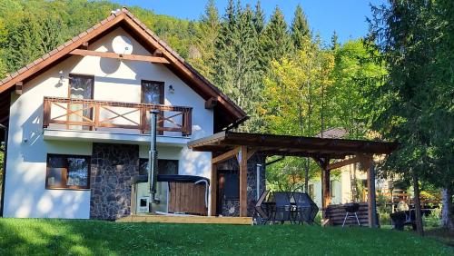 a cottage with a porch and a deck at Chata Krpko in Horná Lehota