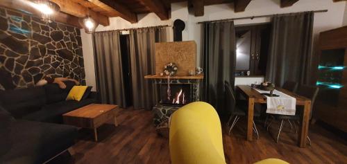 a living room with a couch and a fireplace at Chata Krpko in Horná Lehota