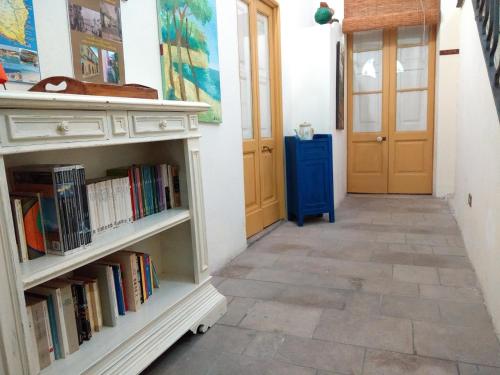 a hallway with a book shelf with books at Antica Via delle Aie in Ruffano
