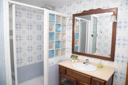 W łazience znajduje się umywalka i lustro. w obiekcie El Olivar Agloipe Ahigal TRCC w mieście Ahigal
