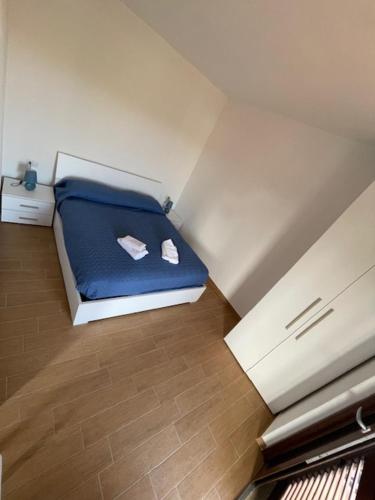 a small room with a blue bed in a attic at case al borgo in Porto Pollo