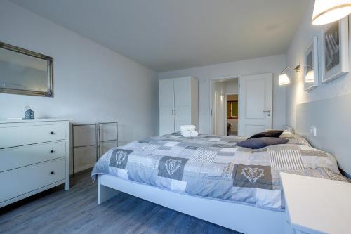 a white bedroom with a bed and a dresser at Mallorca - Can Picafort - Finca Dos Amigos in Muro