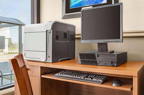 a desktop computer sitting on a desk with a monitor and keyboard at Ramada By Wyndham Niagara Falls near the Falls in Niagara Falls