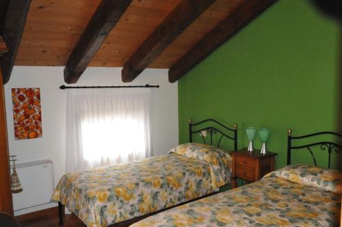 a bedroom with two beds and a window at Agrimargherita in Caorle