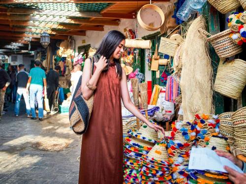 a woman talking on a cell phone in a market at Sofitel Tamuda Bay Beach And Spa in M'diq