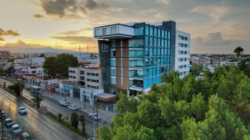 a tall building with a balcony on top of a city at NH San Luis Potosí in San Luis Potosí
