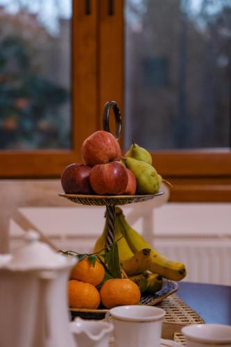 a pile of fruit on a plate on a table at Archontiko Frideriki Luxury Apartments in Chios