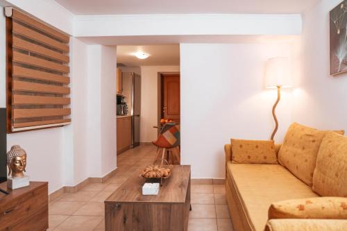 a living room with a couch and a table at Archontiko Frideriki Luxury Apartments in Chios