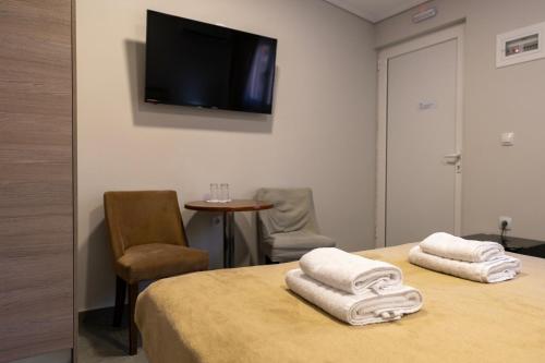 a room with a bed with towels on top of it at Tinas Village Free Transport from/to the airport in Spáta