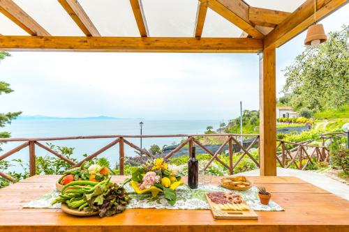 a table with a bunch of fruits and vegetables on it at Starhost - La Casella seaview garden terrace and parking in Cetara