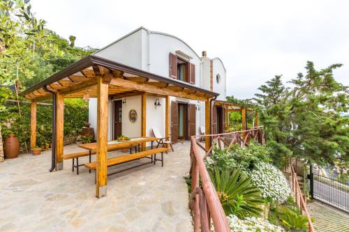 a home with a wooden pergola on a patio at Starhost - La Casella seaview garden terrace and parking in Cetara