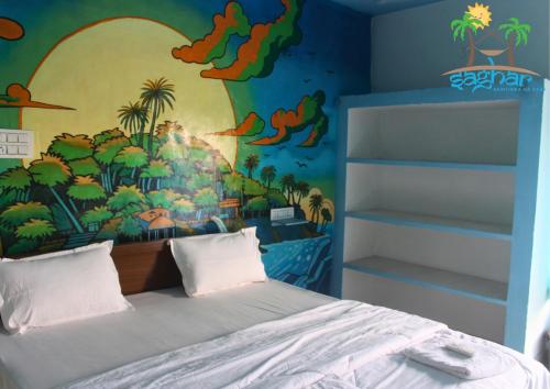 a bedroom with a dinosaur mural on the wall at Saghar House in Visakhapatnam
