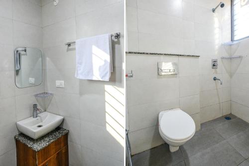 a bathroom with a toilet and a sink at Hotel HC Dream Majestic in Mohali