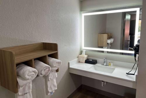 a bathroom with a sink and a mirror and towels at Days Inn by Wyndham Helen in Helen