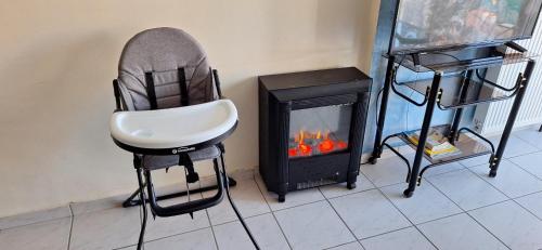 a chair sitting in front of a fireplace at MARIA'S DREAM HOUSE in Eretria