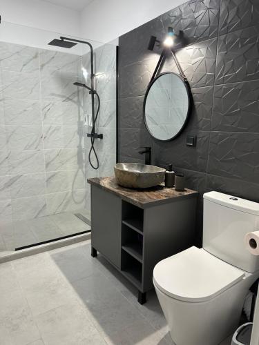 a bathroom with a toilet and a sink and a shower at Apartament Bonton Predeal in Predeal