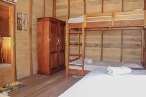 a room with two bunk beds and a cabinet at Toro Simalatcat Surfcamp in Masokut