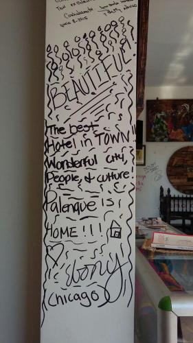 a refrigerator covered in writing on a wall at Hotel - Granja de Animales San Basilio de Palenque in San Basilio del Palenque