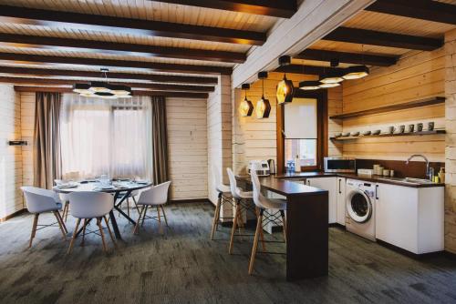 a kitchen and dining room with a table and chairs at TAOR Karpaty Resort & Spa in Skhidnitsa