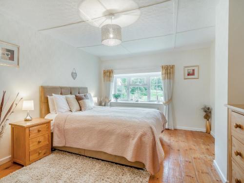 ein Schlafzimmer mit großem Bett und Fenster in der Unterkunft 2 Bed in Bridport 58848 in Powerstock