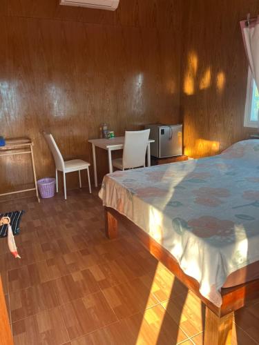 1 dormitorio con 1 cama, mesa y sillas en Baanlungmong en Ko Mak