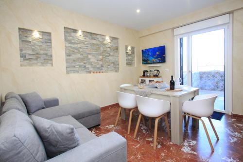 a living room with a couch and a table at Luxury house Il tramonto in Anzio