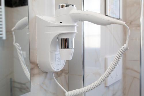 a white blow dryer in a bathroom at Luxury house Il tramonto - Daniele Case Vacanza in Anzio