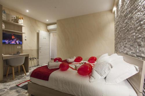 a bedroom with a large bed with red pillows at Luxury house Il tramonto - Daniele Case Vacanza in Anzio